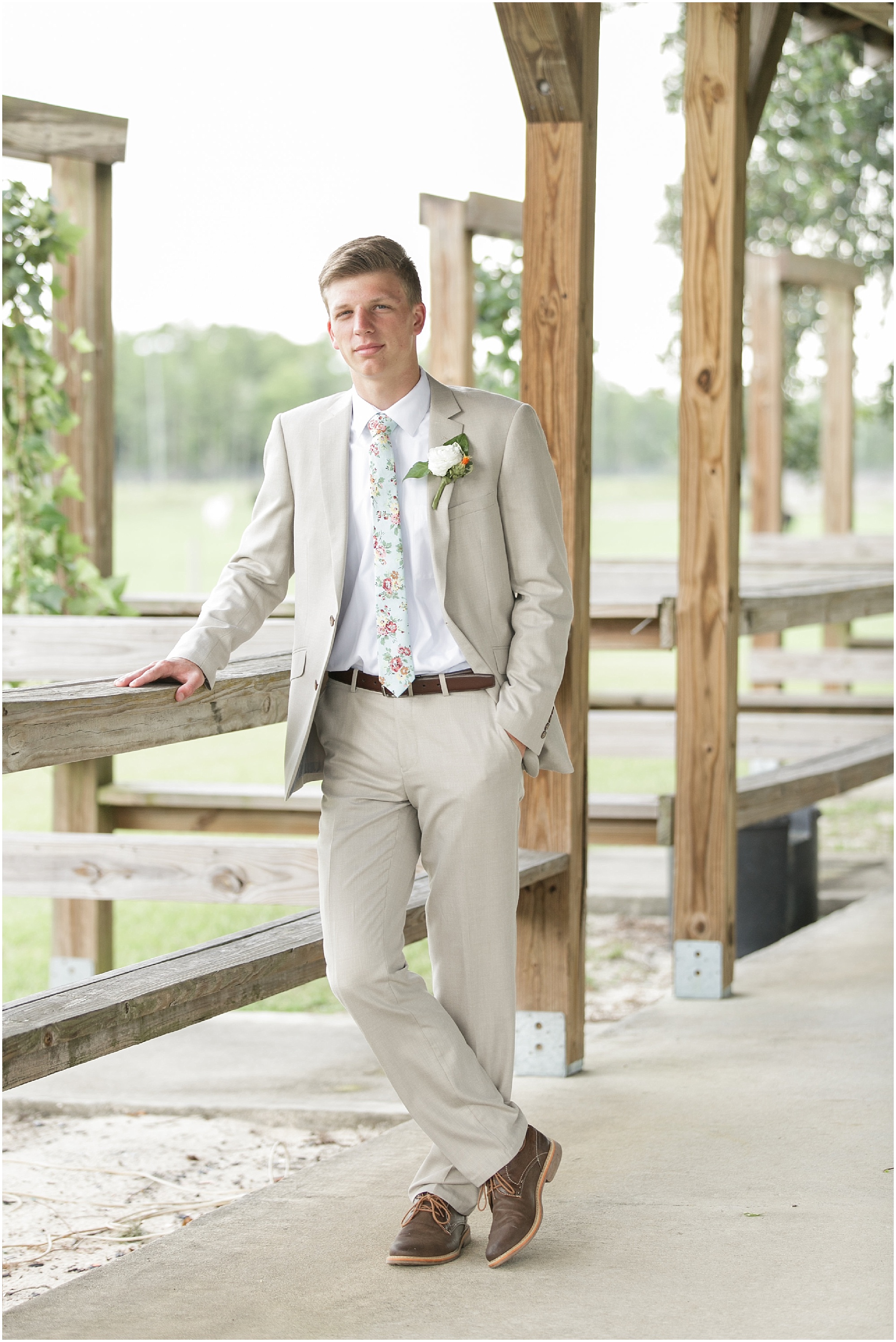 Groom in a light neutral color suit. 