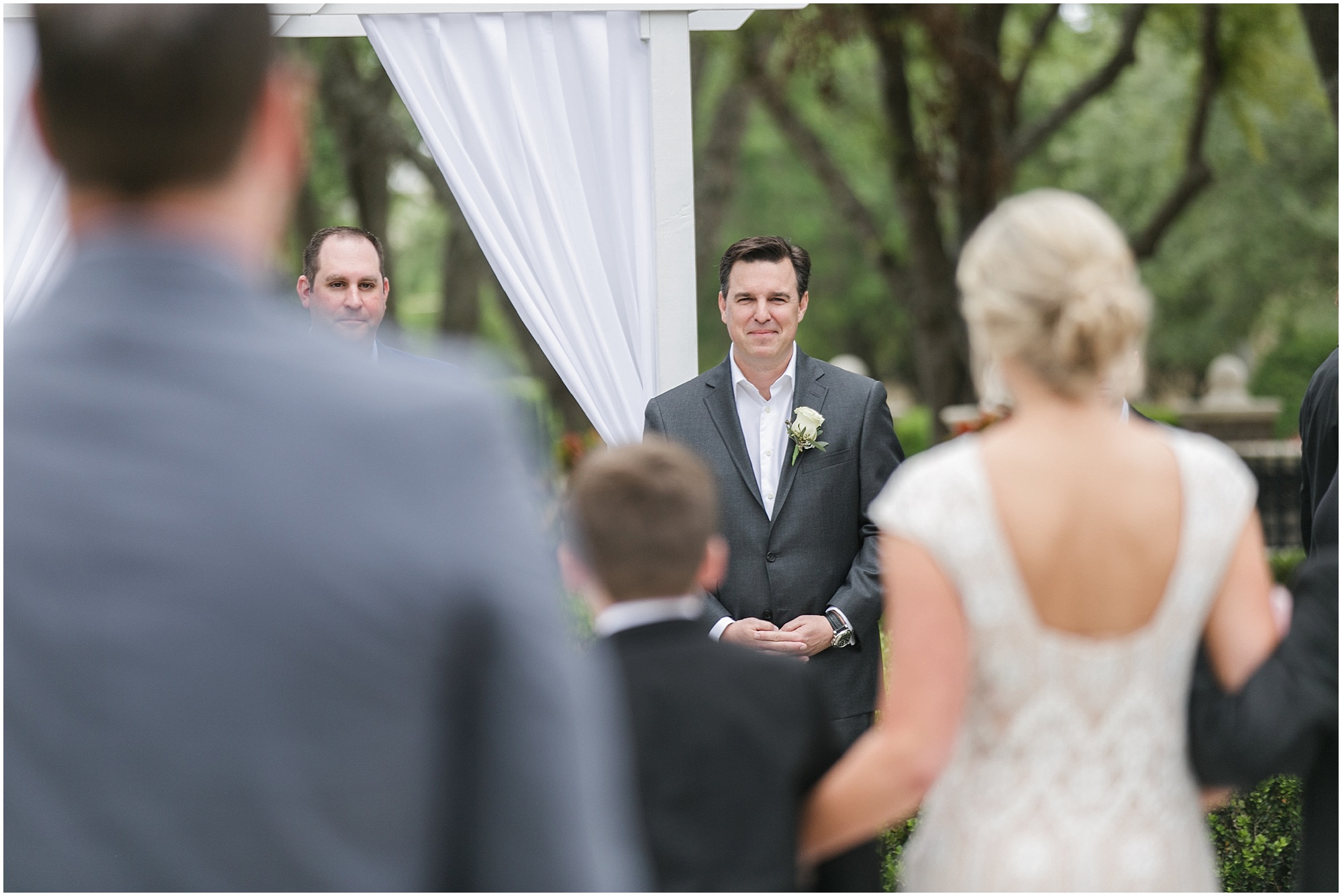 Photo of the groom as he's watching his bride walk down the aisle. 