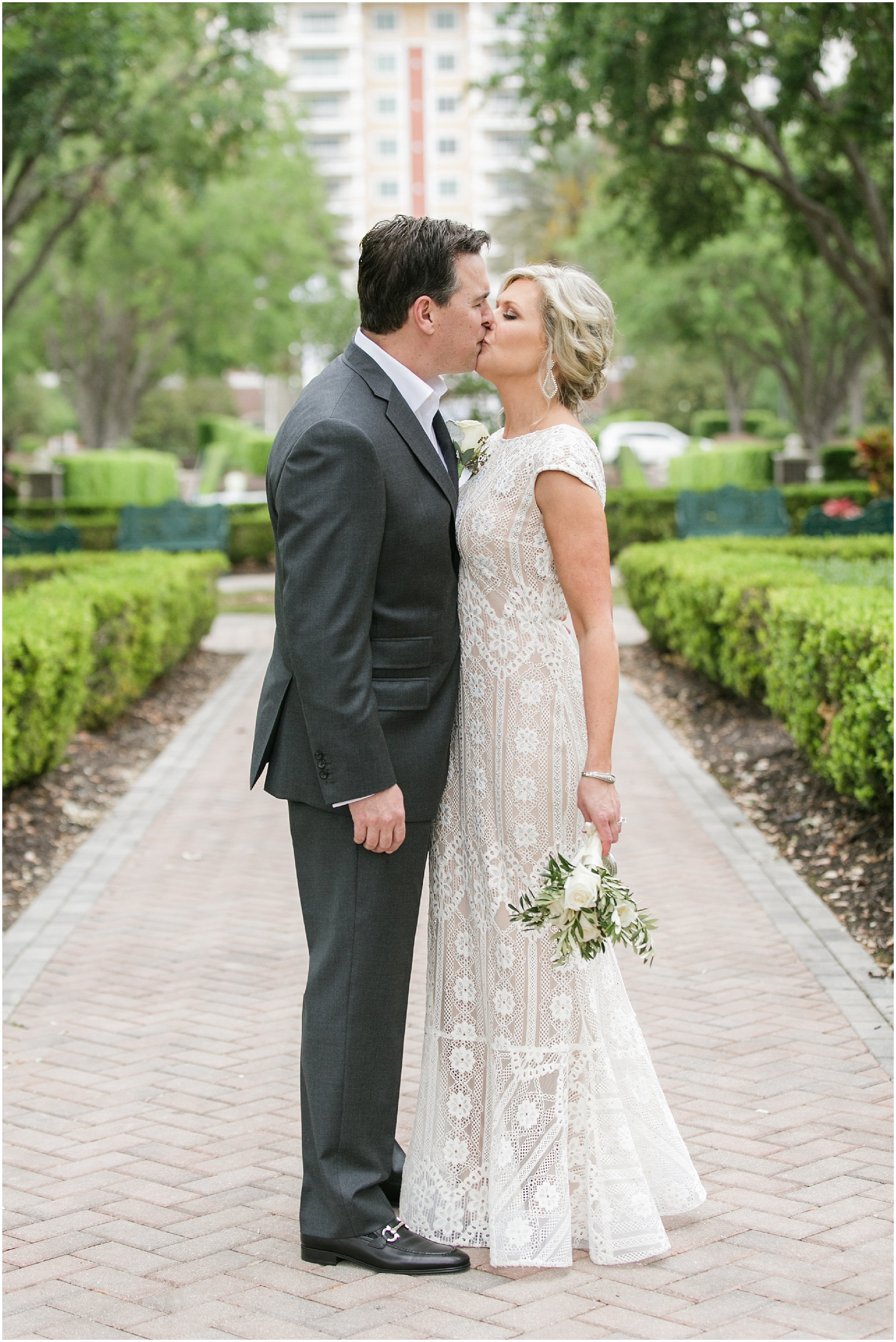 Beautiful Blended Family wedding bride and groom kissing after their ceremony.