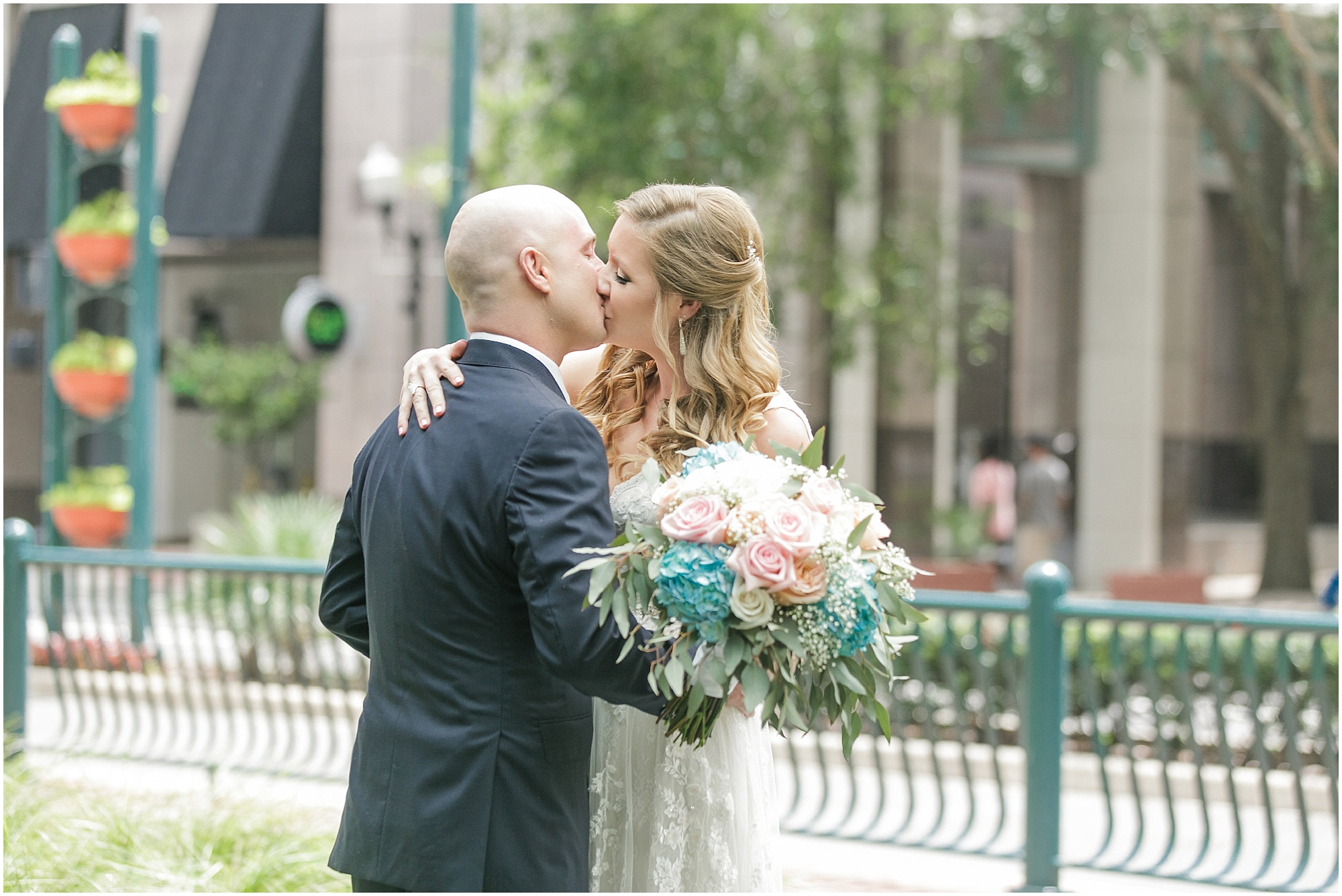 Bride and groom kissing outside in downtown Orlando. 