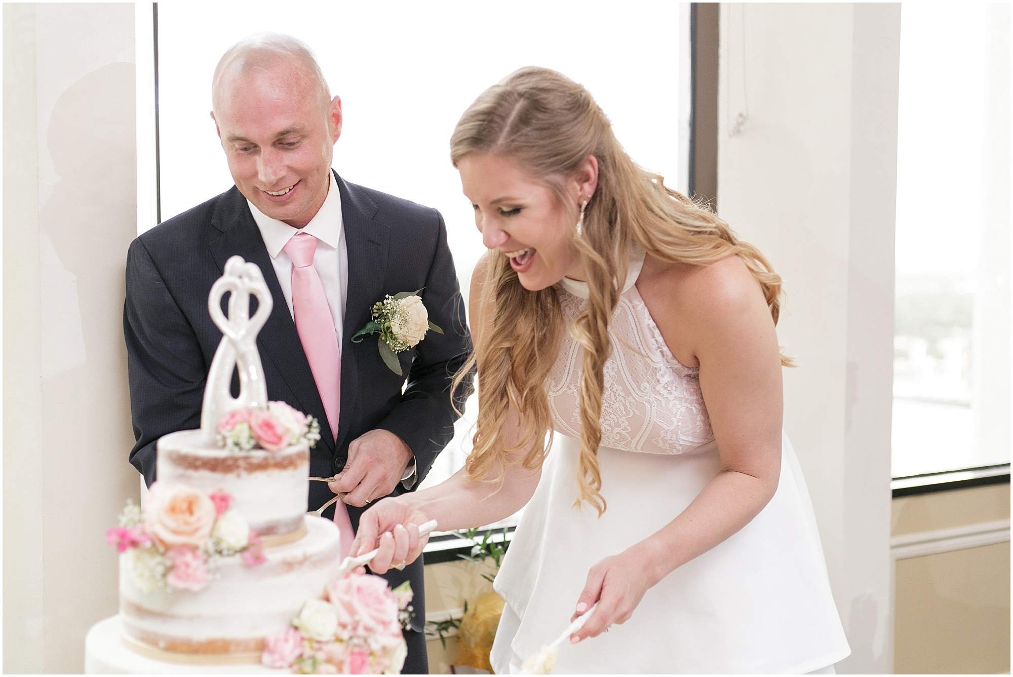 Bride and groom slice their wedding cake. 