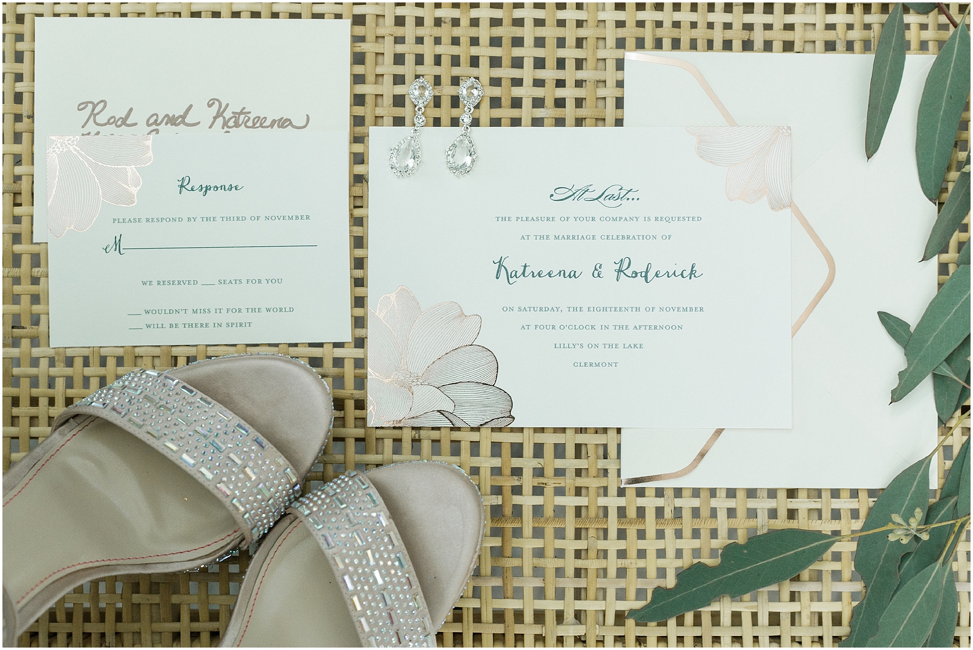 Sparkly shoes and earrings along with wedding invitations to an intimate lakeside wedding.