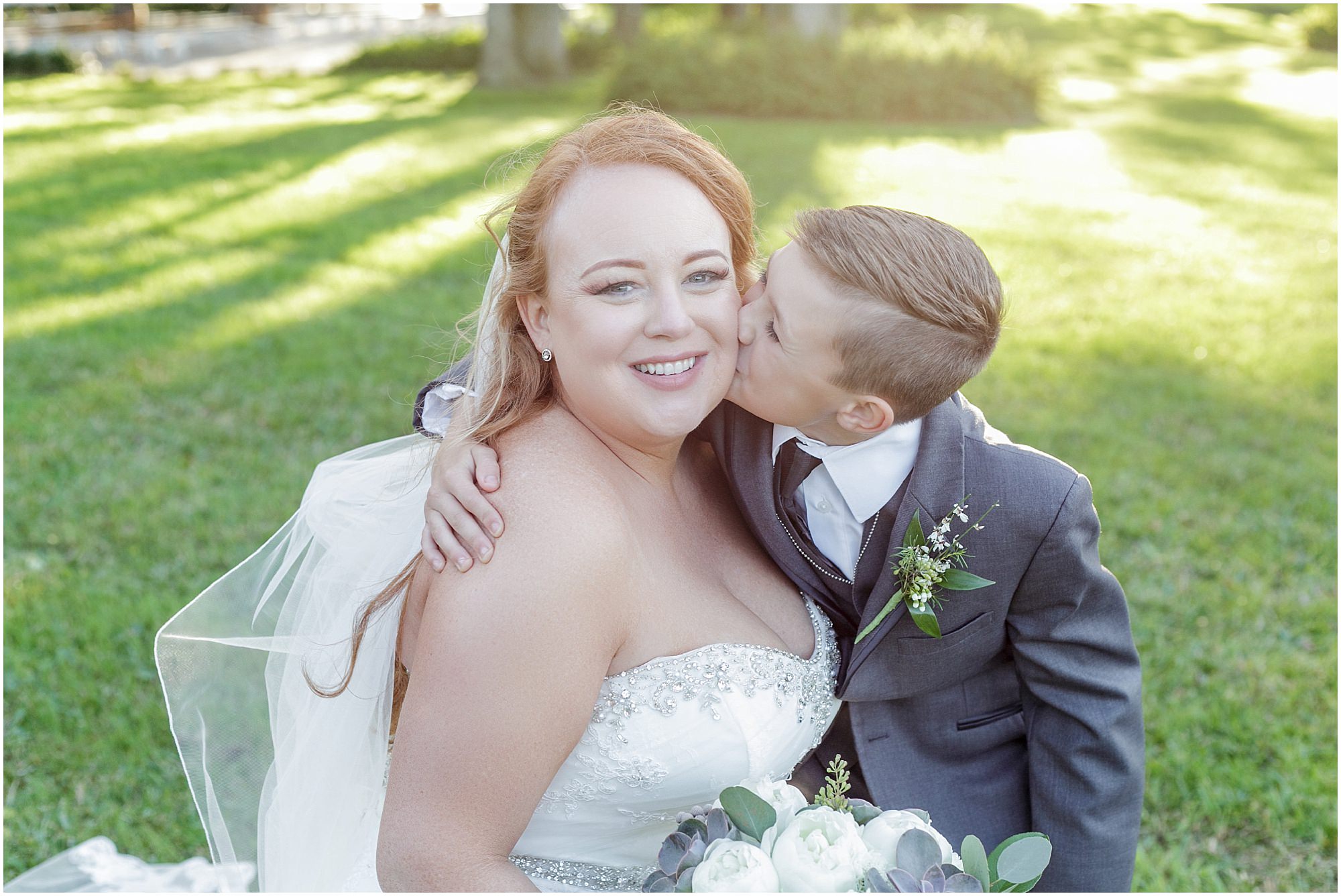 Brides son gives his mom a kiss on the cheek. 