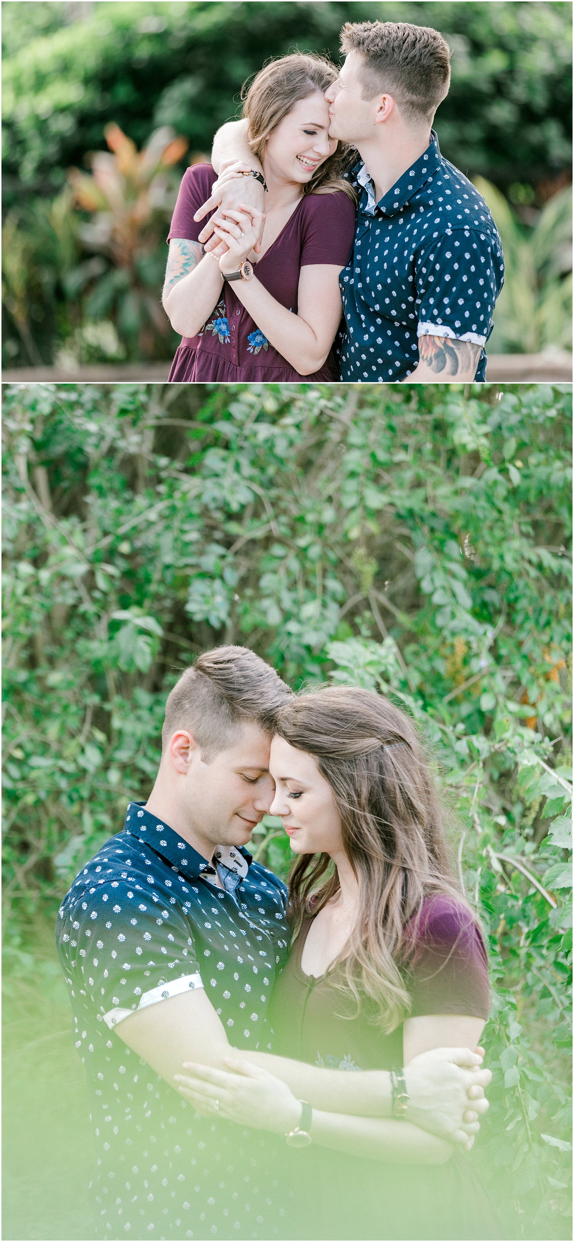Couple cuddle with each other while standing in the middle of greenery. 