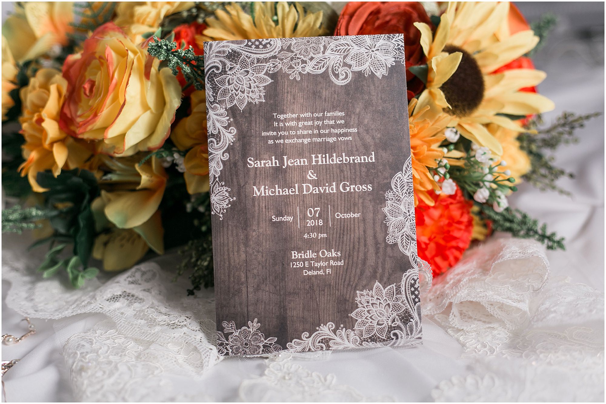 Enchanted Forest Wedding woodgrain print invitations with yellow flowers in the background