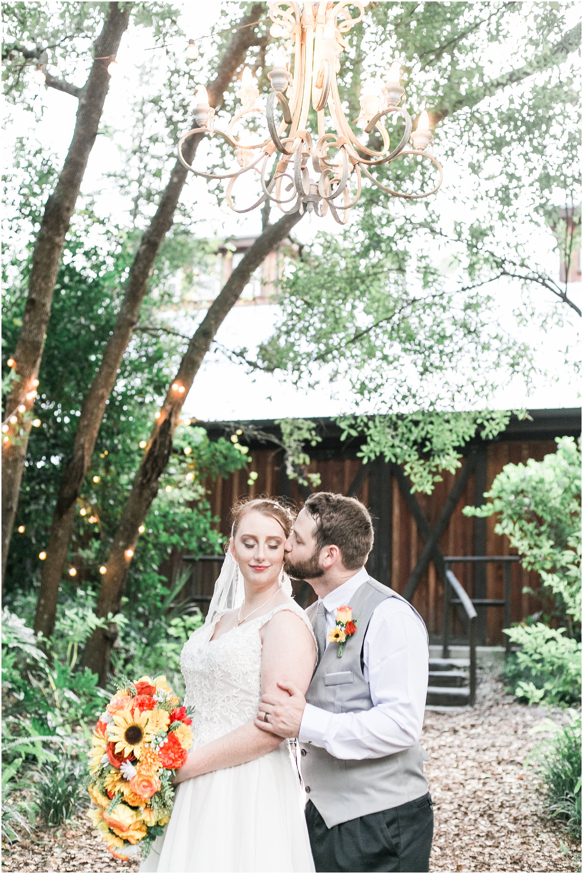 Enchanted Forest Wedding couple standing under a chandelier and market lights hanging from trees