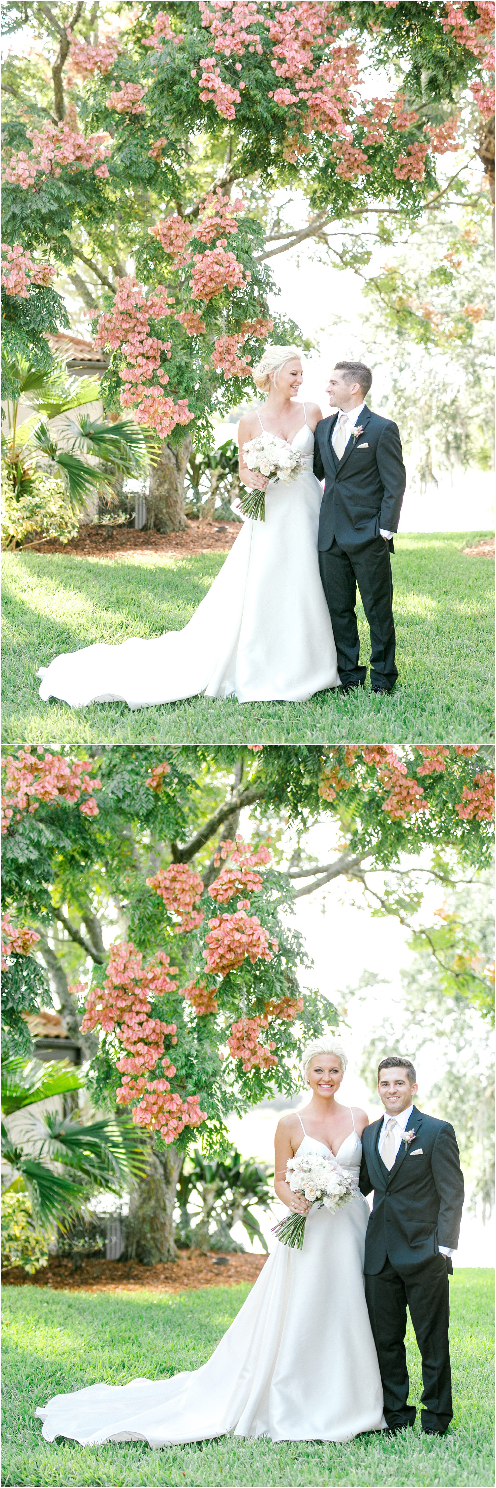 Bride and groom taking portraits standing under green trees with pink flowers on them