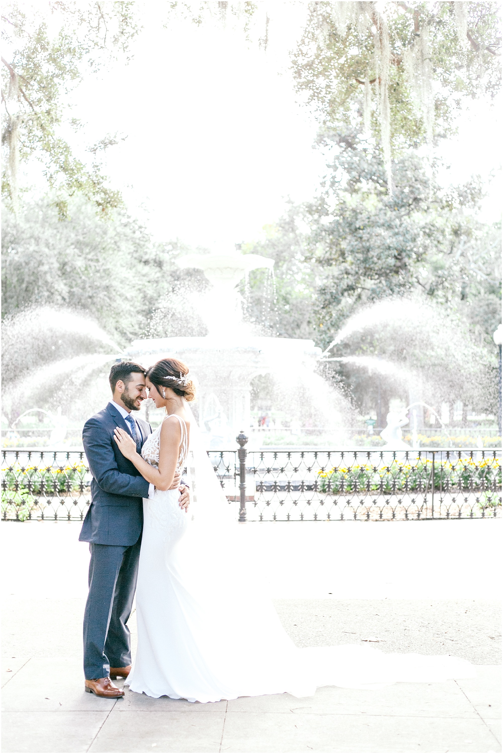 Sweet Savannah wedding couple standing in front of the fountain in Forsyth Park.