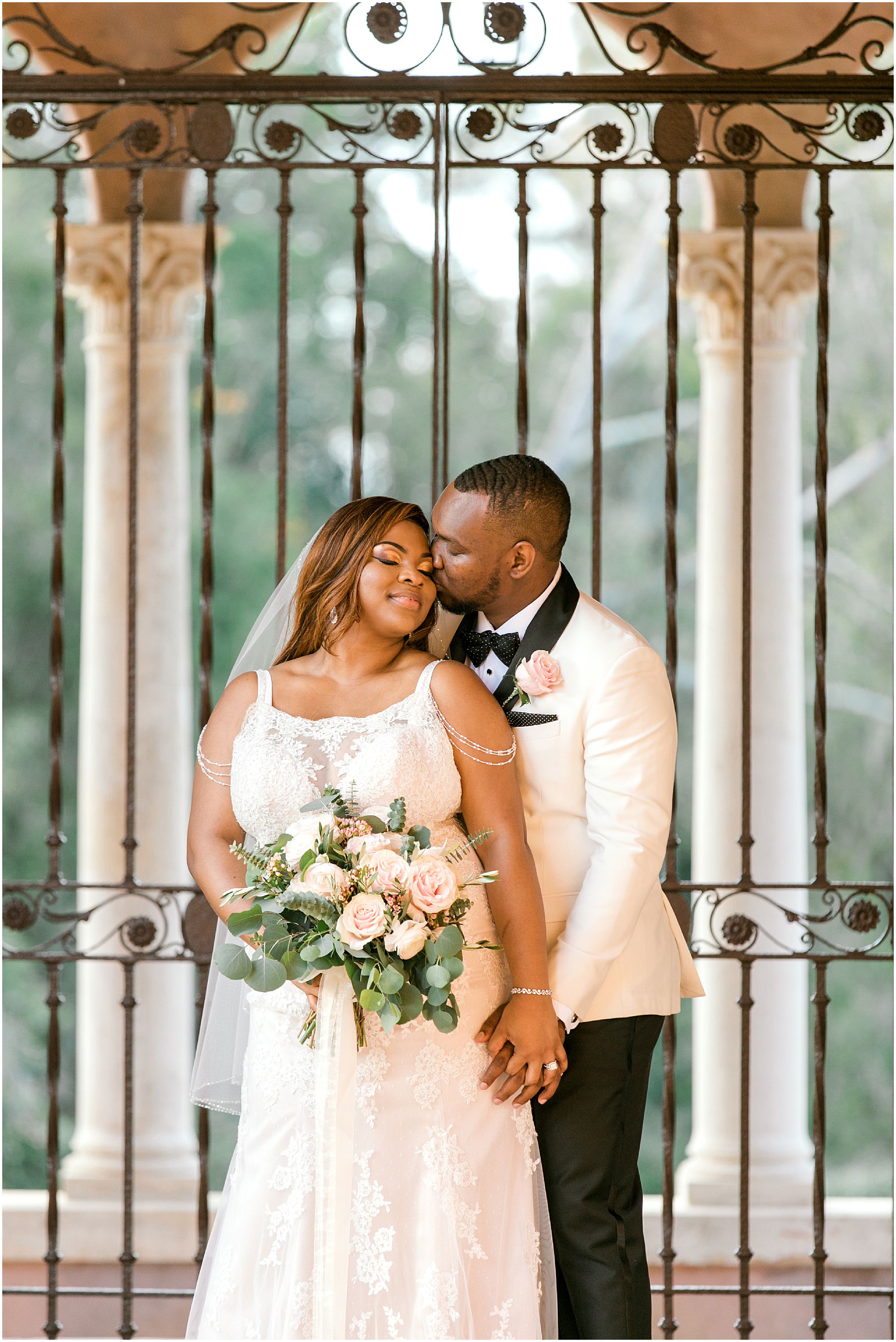 Intimate Howey Mansion Wedding couple taking portraits in front of antique iron gates