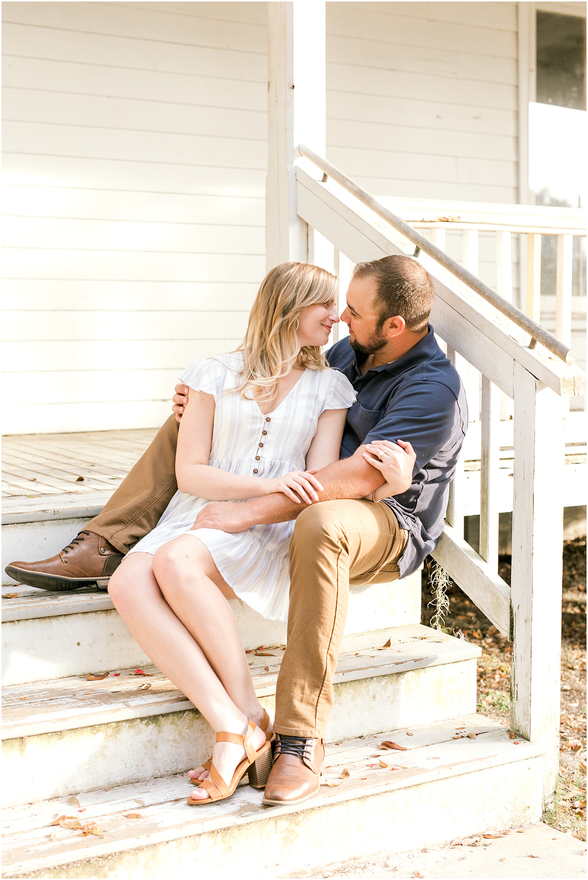 St Augustine Engagement Session couple sitting on the steps of a historic house in Alpine Groves Park