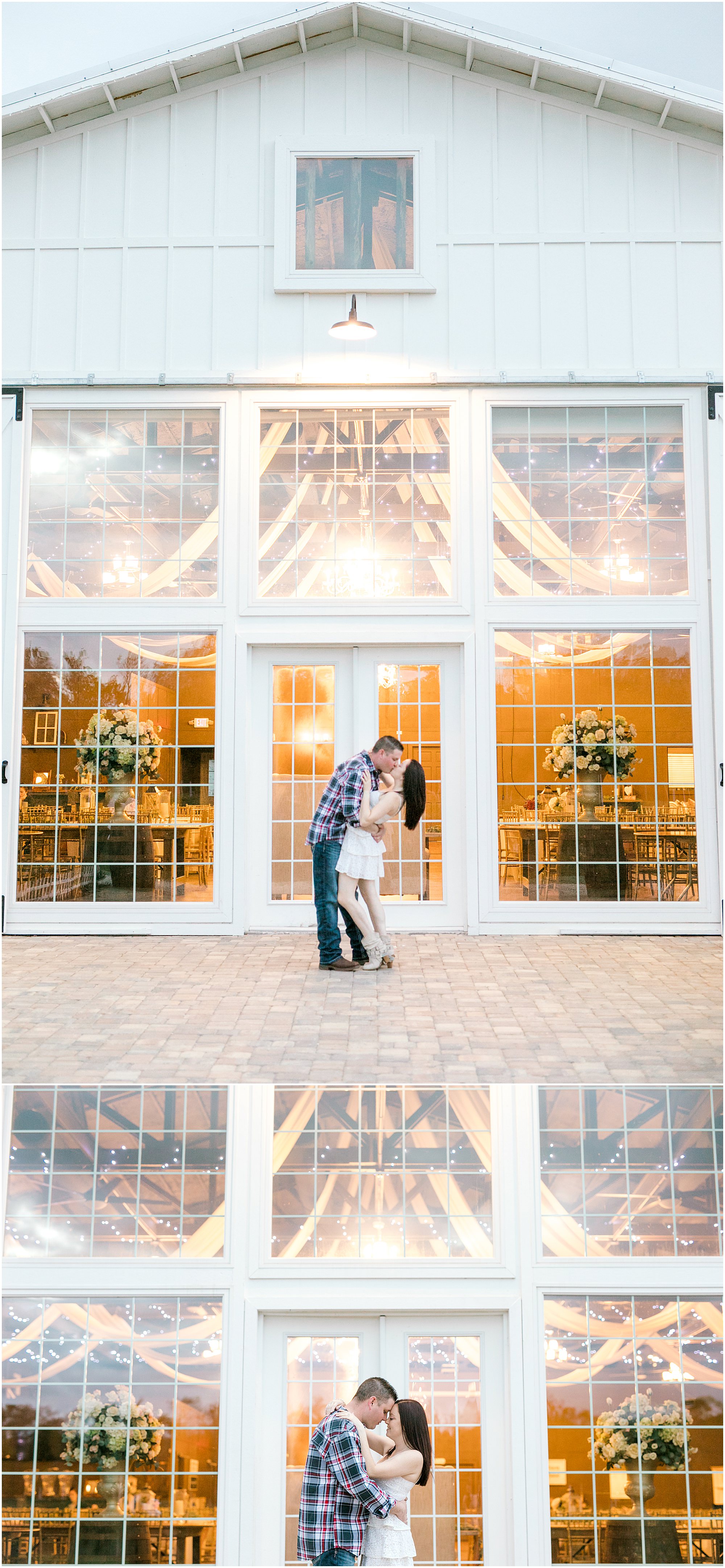 Couple kiss while standing in front of large glass windows on the side of the barn