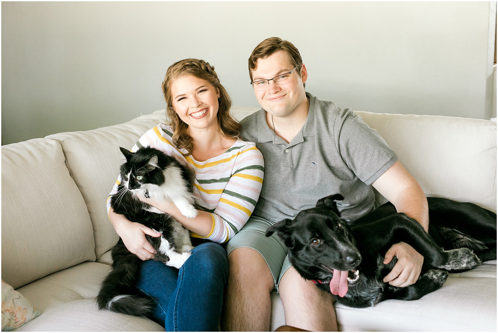 Sweet Fort De Soto engagement session couple on the couch with their dog and cat
