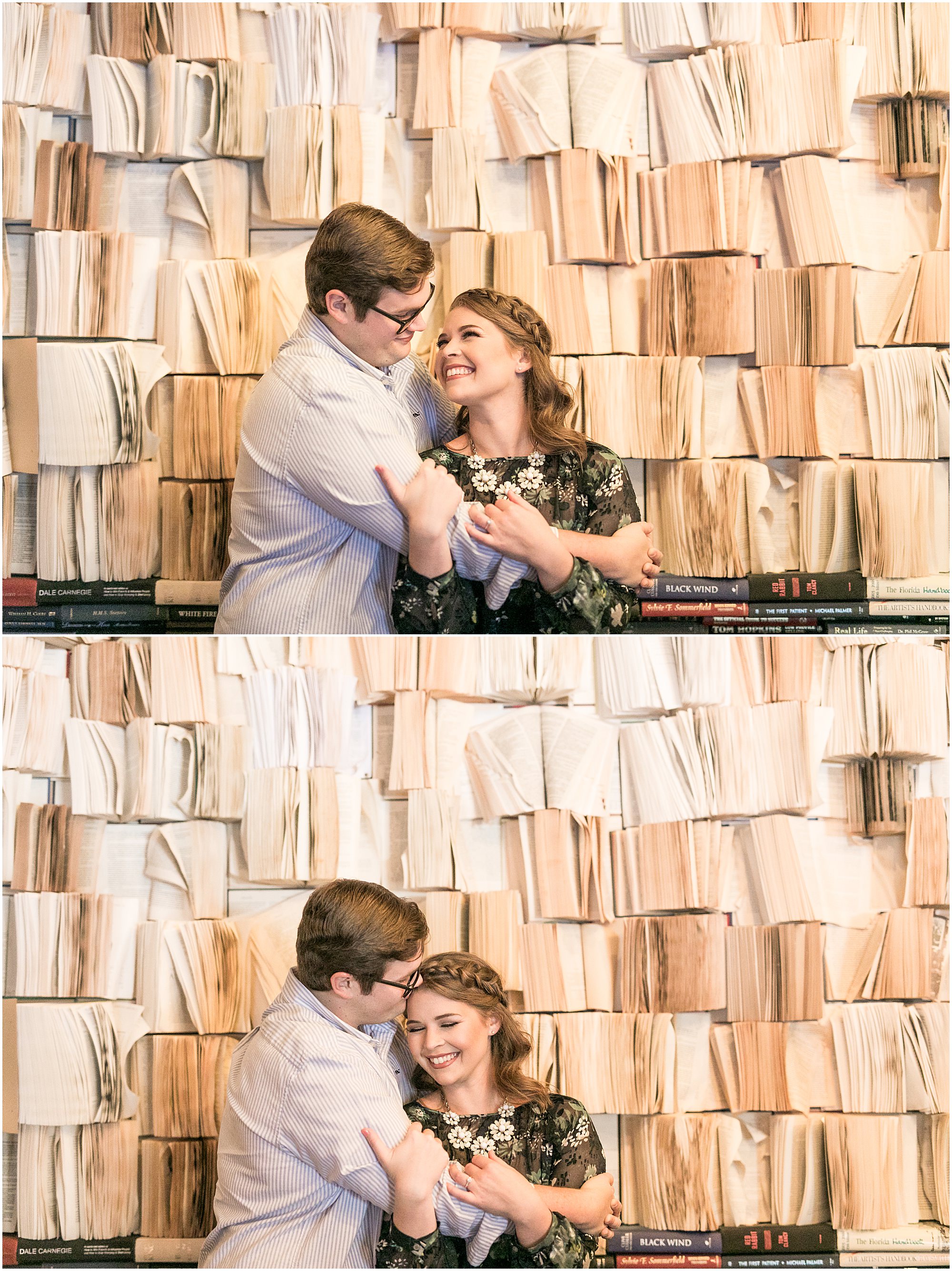 Sweet engagement couple cuddle while standing in front of a wall made of opened books