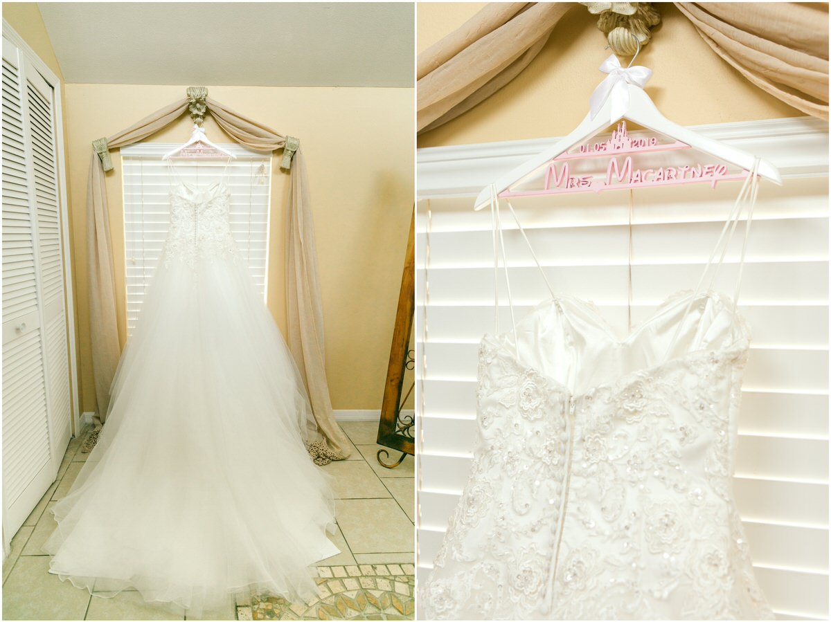 Wedding dress hanging up in front of window. Hung on a Disney font inspired hanger