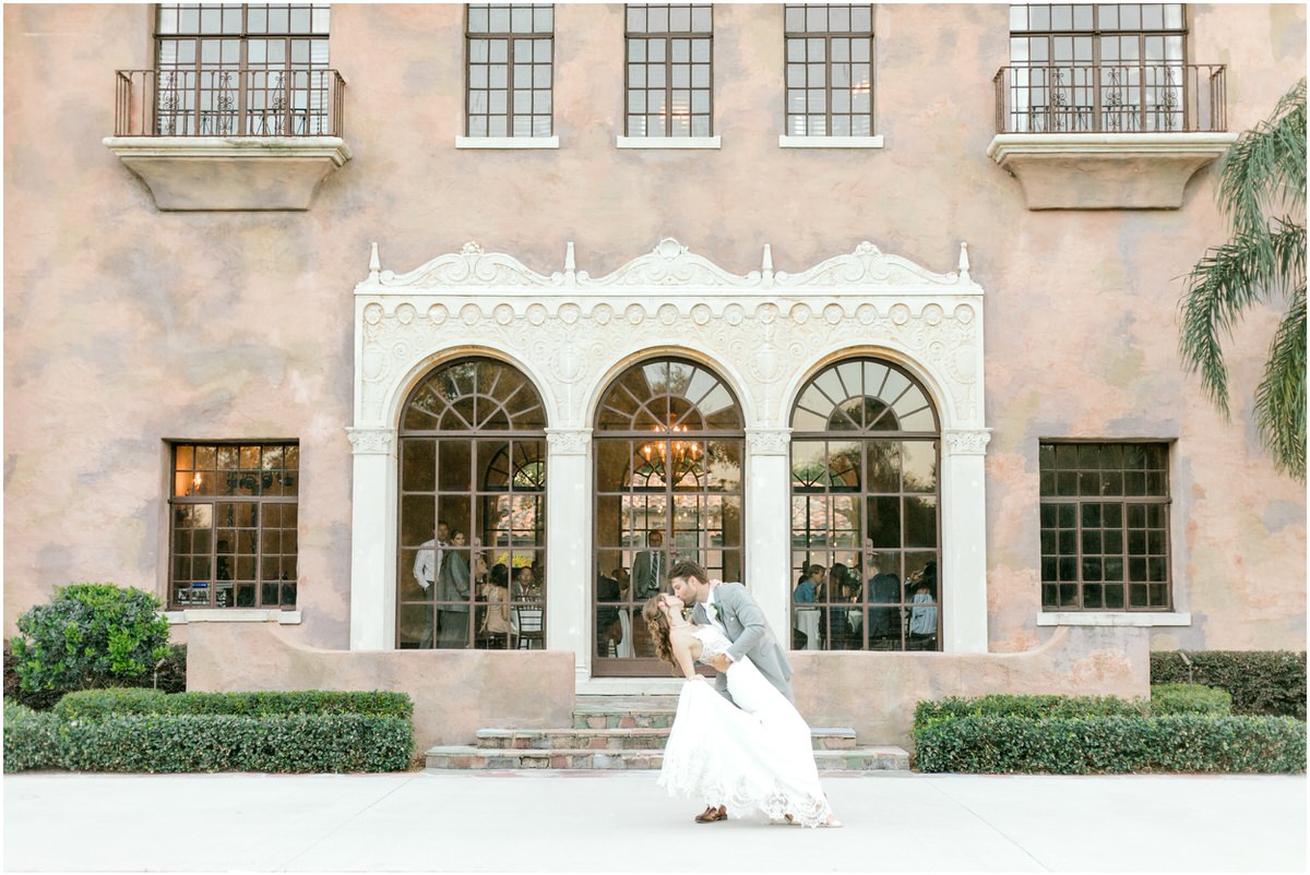Bride and groom kissing outside of the Howey Mansion