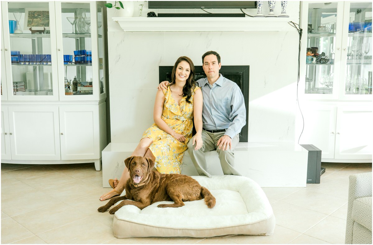 Couple with dog in front of fireplace