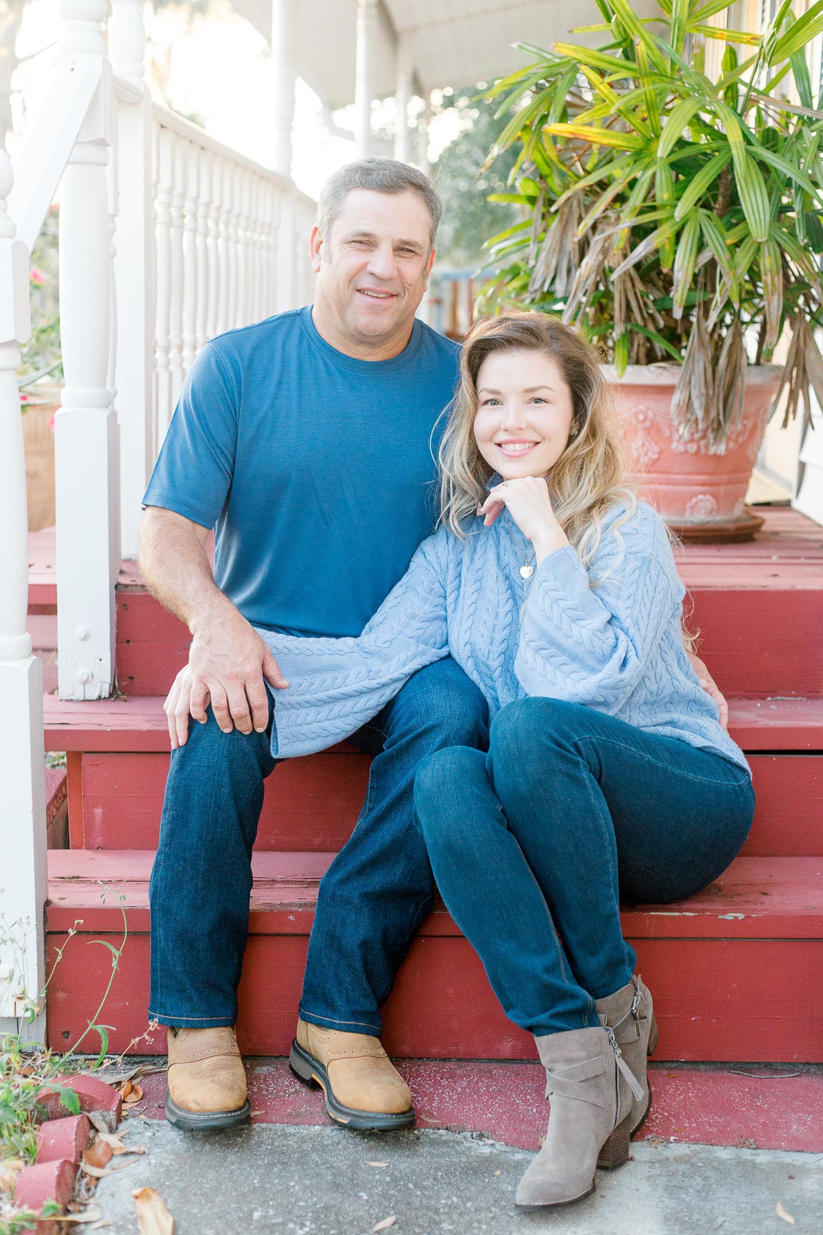 engaged couple sitting on porch steps