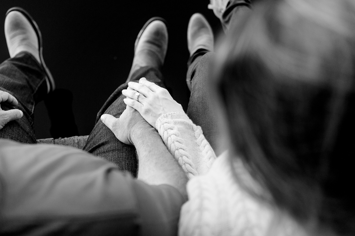 black and white photo of engagement couple holding hands