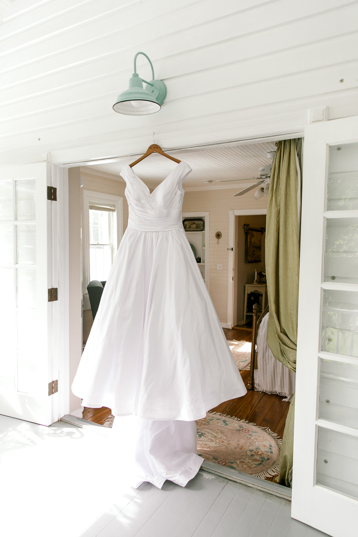 Wedding dress hanging in the doorframe 