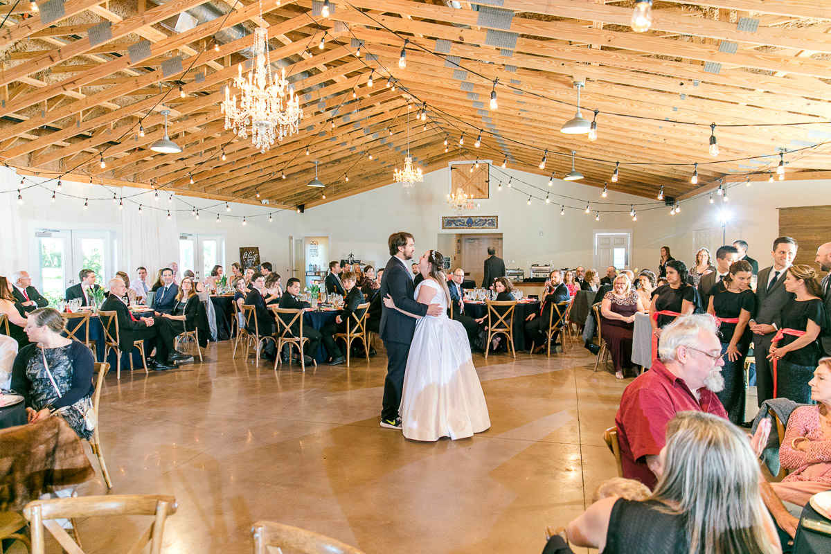 guests watch as bride and groom dance
