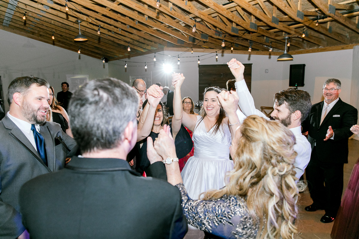 bride dances with guests at wedding reception