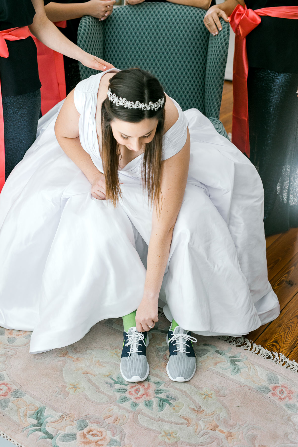 bride putting on wedding sneakers