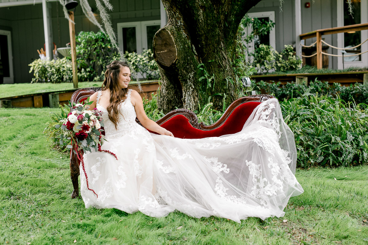 Bride sitting on vintage red couch