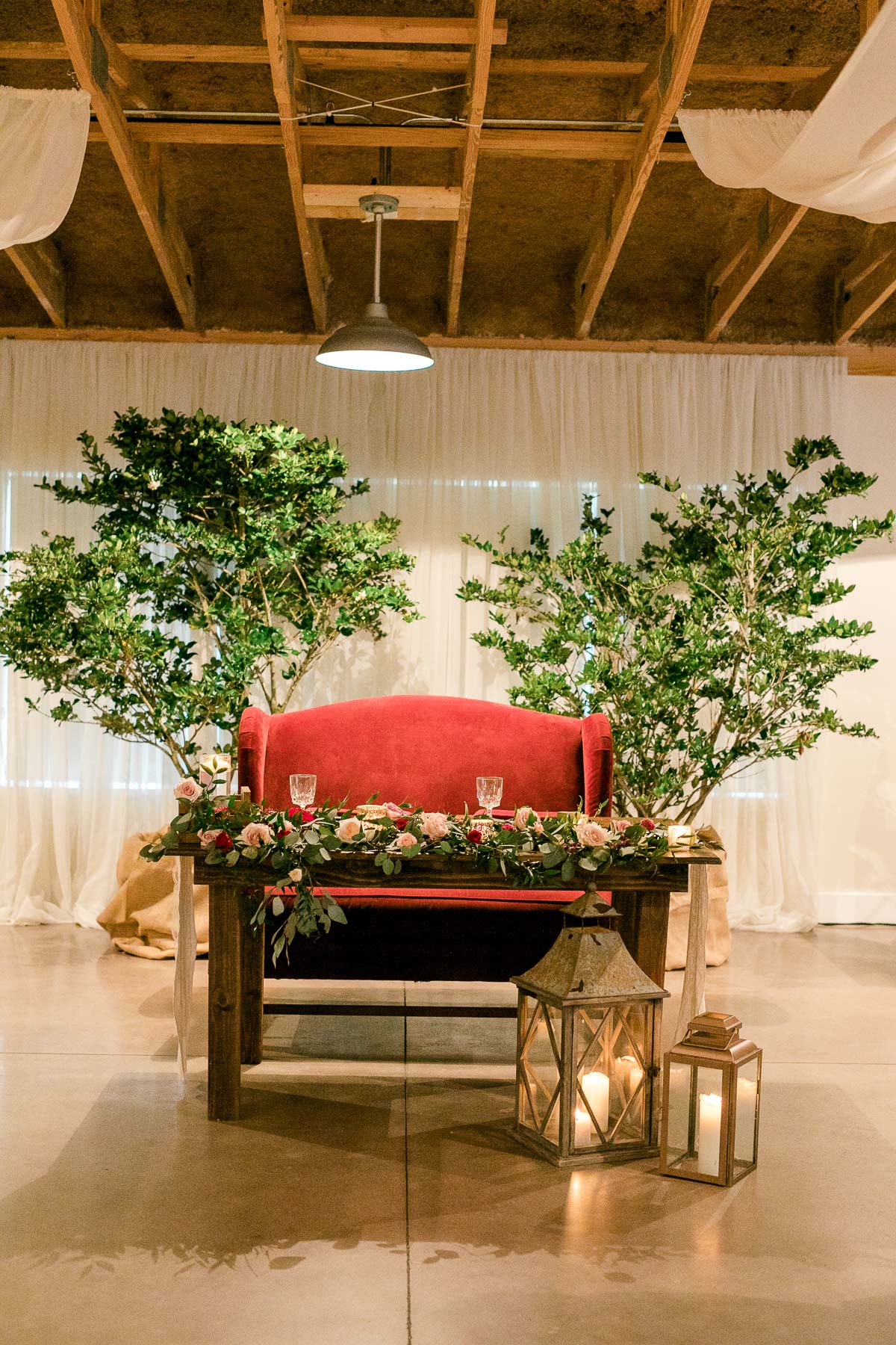 Sweetheart table with a large red couch