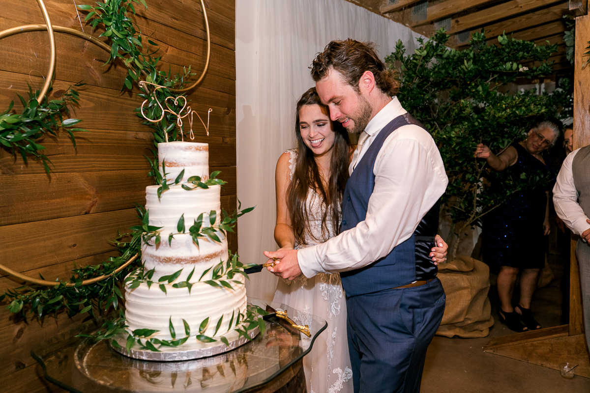 bride and groom cut into their wedding cake