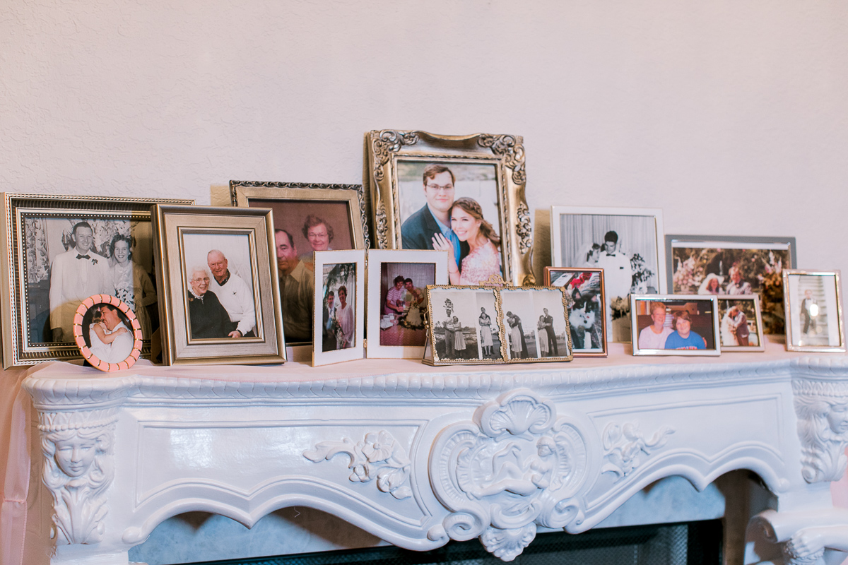 Fireplace mantle with family photos for wedding decor