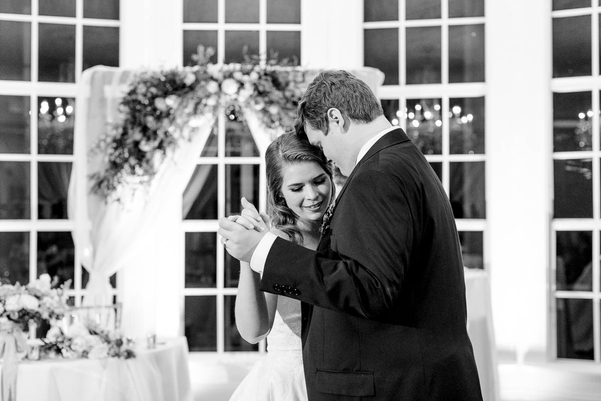 Black and white photo of bride and groom sharing thier first dance