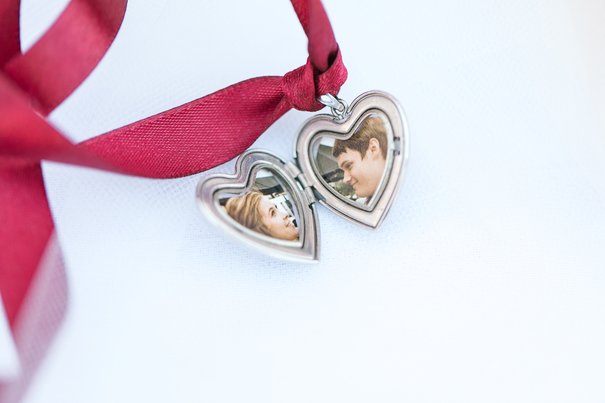 Silver locket with bride and grooms photos