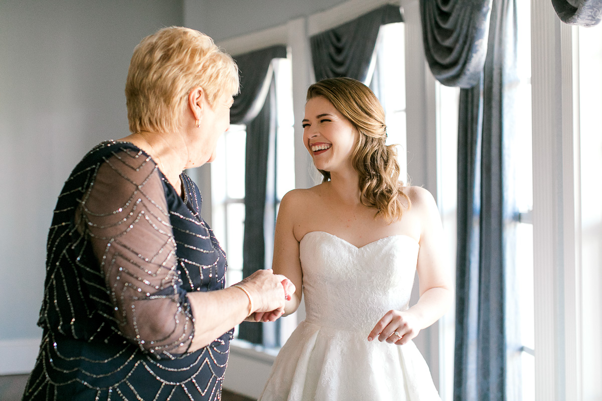 Bride and grandmother smiling at each other