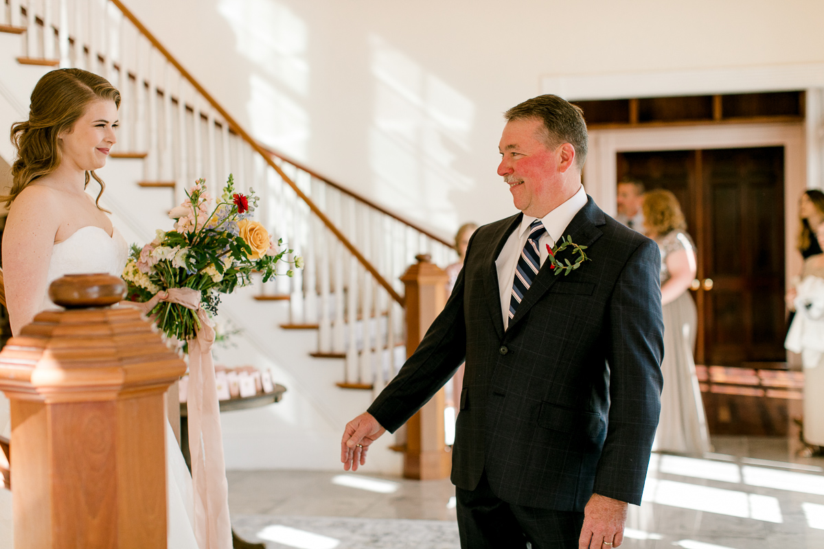 Father of the bride being surprised by his daughter