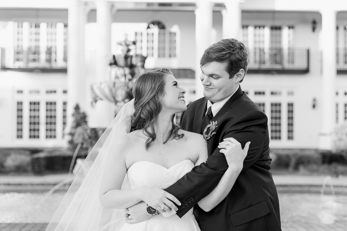 Black and white photos of bride and groom hugging in front of Luxmore Grande Estate wedding venue