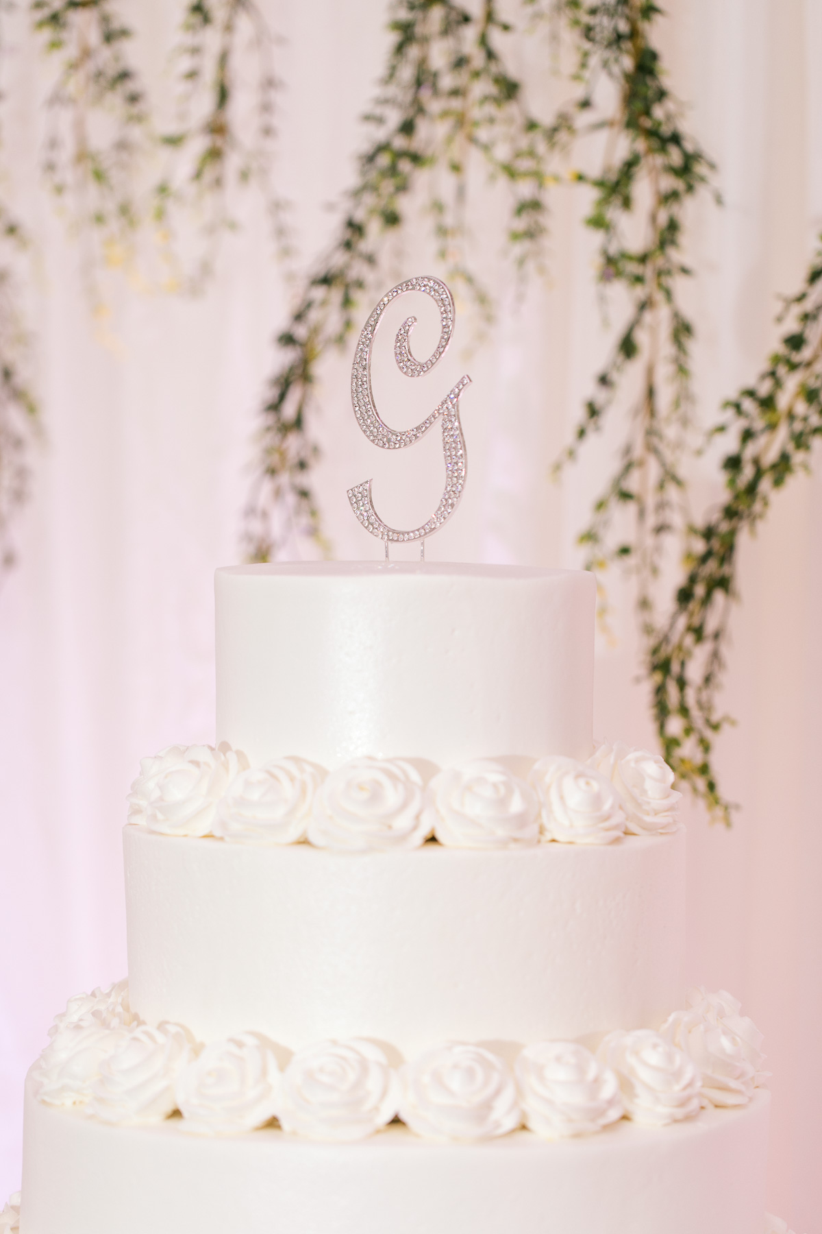 White wedding cake with custom wedding topper