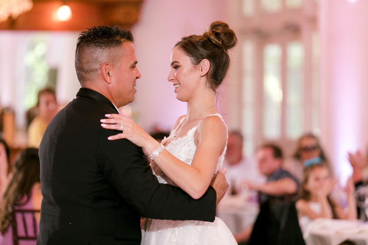 Bride and her father dance together at wedding reception