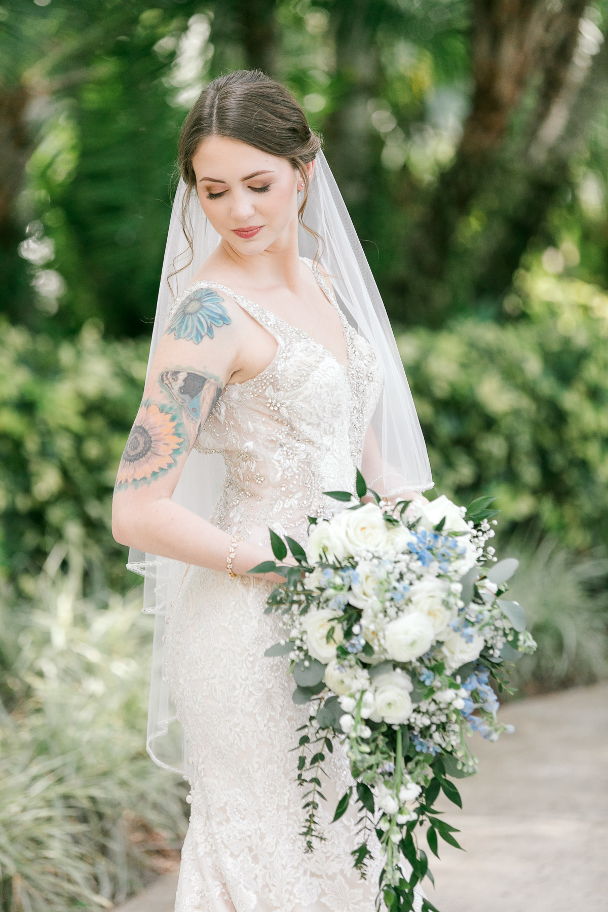 Bride and vintage wedding dress and white and blue bouquet