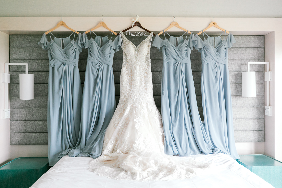wedding dress and blue bridesmaids dresses hanging