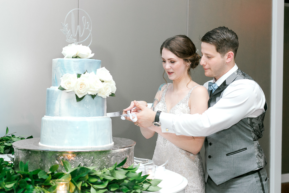 Bride and groom slice into their wedding cake