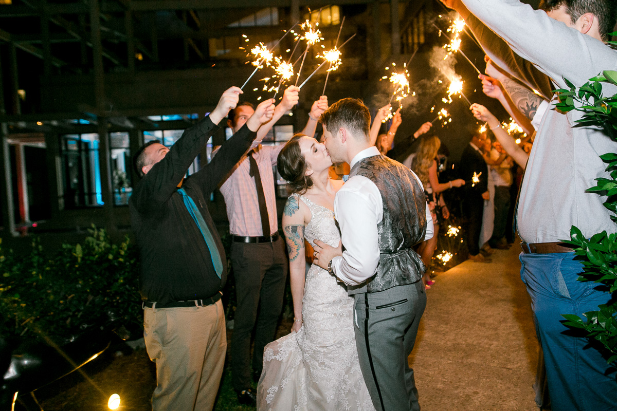 Bride and groom kiss at the end of sparkler exit 